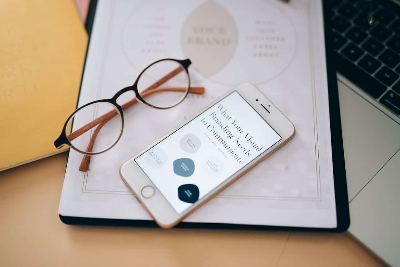 Photo by Leeloo The First: https://www.pexels.com/photo/an-eyeglasses-near-the-mobile-phone-on-white-paper-8970669/ - business branding