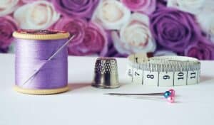Photo by Suzy Hazelwood: https://www.pexels.com/photo/spool-of-purple-thread-near-needle-thimble-and-measuring-tape-1266139/ -- sewing kit